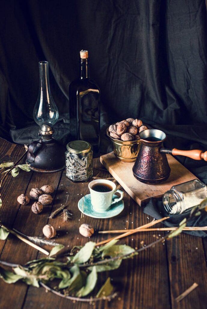 pexels-photo-4282479 Coffee cup and pot with walnuts bowl placed on table with various spices and retro decorations